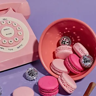 a pink telephone and pink macarons