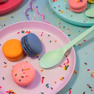 a plate of macarons and a spoon