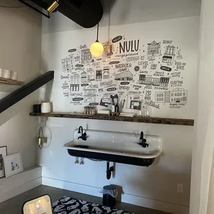 Wall art and decor near the quaint sink area.