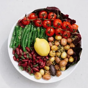 a bowl of vegetables and a lemon
