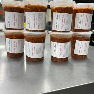 a stack of six cups of chili sauce