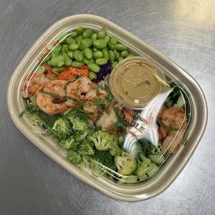a container of shrimp, broccoli, and beans
