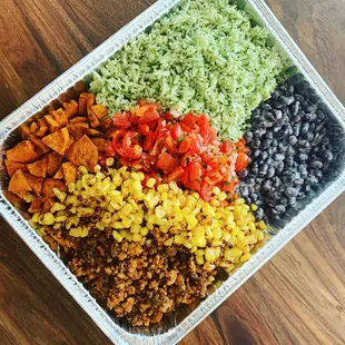 a plastic container filled with rice, beans, corn, and black beans