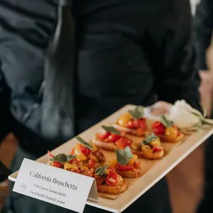 Server at an event with tray passed appetizer, California Bruschetta