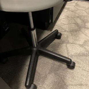 a white office chair with black legs