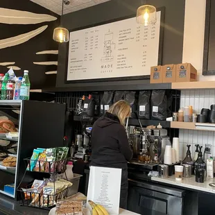 a woman working at a coffee shop