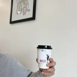 a man holding a cup of coffee