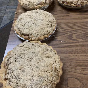 four pies on a wooden table