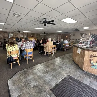 people sitting at tables in a restaurant