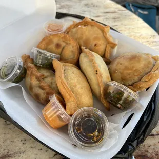 Six different empanadas and three sauces.