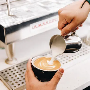 a bari serving a cup of coffee