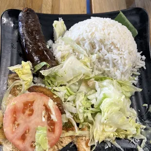 Morcilla, salad, rice, a chicken breast, and tiny plátano.  Morcilla was bought Separately for $3.00 more.