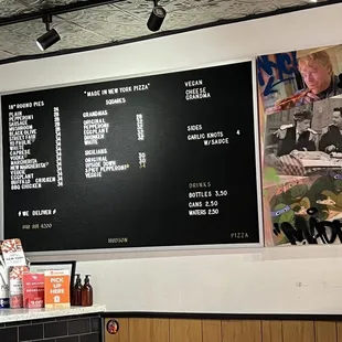 Price &amp; menu for whole pizzas, drinks, and side items as of 14 April 2023. Also a bit of wall art.