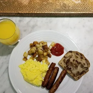 a breakfast of eggs, sausages and toast