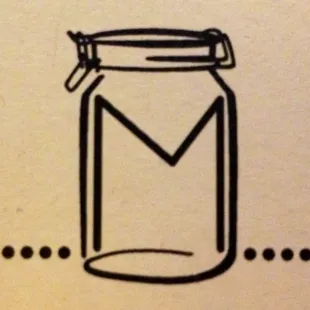 a glass jar with a letter m on it