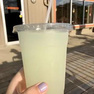 a hand holding a drink