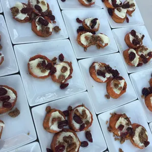 Baked sweet potato rounds with goat cheese, honey, dried cranberries, and caramelized  pecans