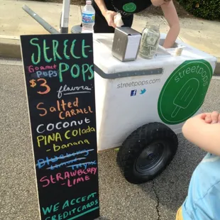 a woman selling a street food cart