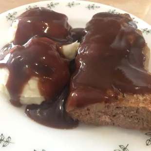 Meatloaf wrapped in cabbage with mashed potatoes and gravy. A meal for the day