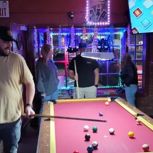 a man playing pool in a bar