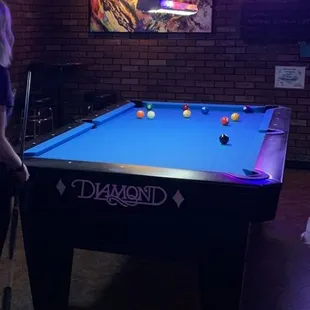 a pool table in a dimly lit room
