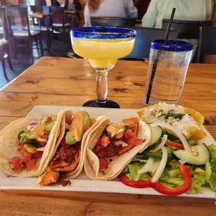 Mahi-mahi tacos with a side salad and lime cilantro rice