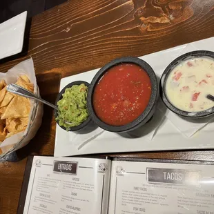 Chips, guacamole, salsa, and queso dip