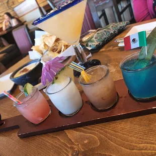 Margarita flight, white sangria and  churizo queso with chips on the table