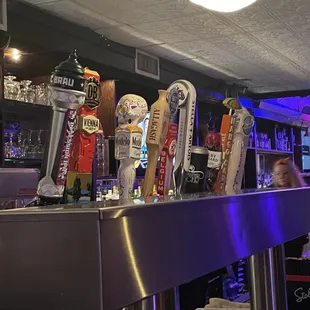 a row of beer taps in a bar