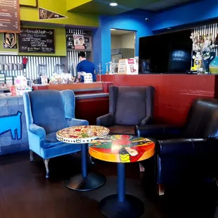 two chairs and a table with a pizza on it