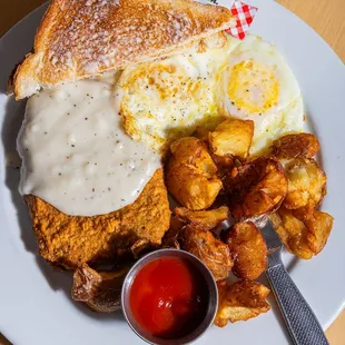 Chicken Fried Steak and Eggs with over-medium eggs and white toast