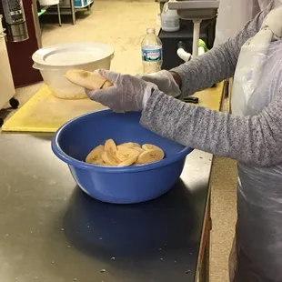 a woman preparing food in a kitchen