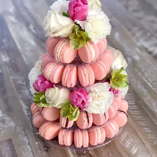 a stack of macarons with flowers on top