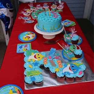 a table with cupcakes and a cake