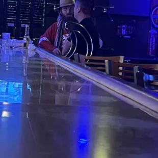 two men sitting at a bar