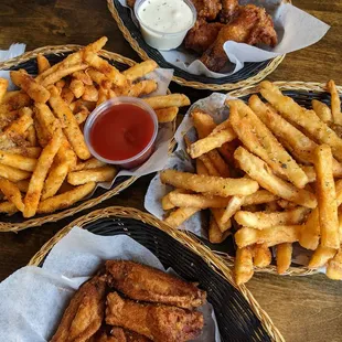 baskets of fried chicken wings and french fries