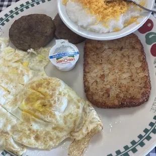 Breakfast plate with sausage, hash browns and cheese grits.