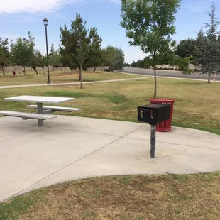 Picnic table with its own grill and trash can