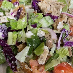 Fatoosh mixed up from carryout container. Includes green pepper, cucumber, red onion, tomato and fried  pita chips in a sweet dressing.