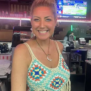 a smiling woman in a bar