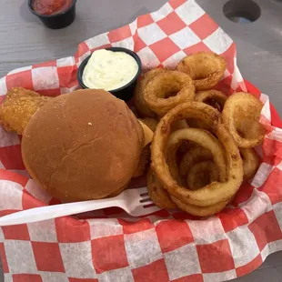Cod fish sandwich with onion rings.