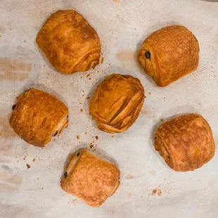 Delicate golden croissants arranged on a tray, promising a buttery indulgence with every flaky bite. A heavenly bakery treat.