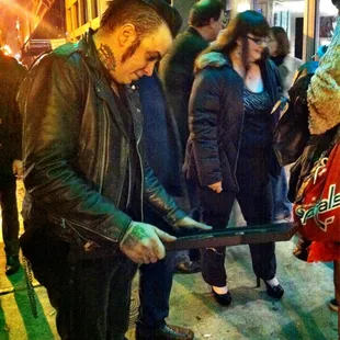 Switchblade Syndicate guitarist Paul Burgio admiring their best punk band award.