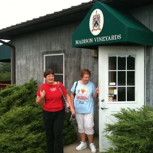 two women standing in front of a building