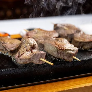 Prime Beef  Hot Lava Rock - skewered marinated filet mignon;  romesco, smoked sea salt,  red pepper aioli; giardiniera; cooked at your table