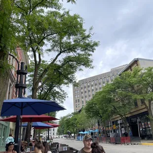 a group of people sitting at outdoor tables