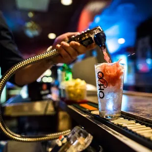 a bartender pouring a drink