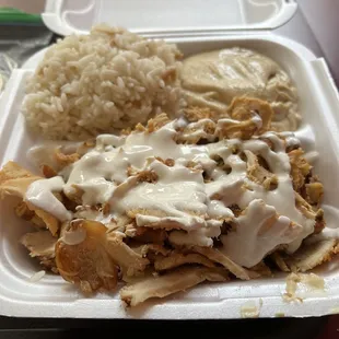 Rice pilaf, hummus, chicken shawarma with garlic sauce (pita on the side).