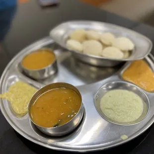 a silver plate with a variety of sauces