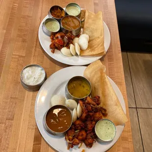 two plates of food on a wooden table